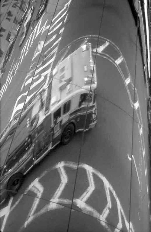 Photo by Pete Burke. Engine 10 reflecting on World Trade Center walkway - both were destroyed on 9/11/01.  © Pete Burke