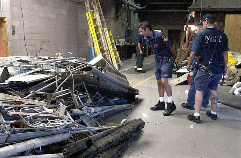 Ladder 10 firefighters assess the current condition of Ten House.  Photo by Mike De Sisti © 2002 Appleton Post-Crescent