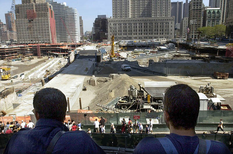 DIFFICULT SIGHT: New York City firefighters look over the site where the World Trade Center once stood from the top of the Engine 10, Ladder 10 firehouse, known as the Ten House. The firehouse has been unusable since the Sept. 11 attack on the WTC.  Photo by Mike De Sisti 8/10/02 © 2002 Appleton Post-Crescent
