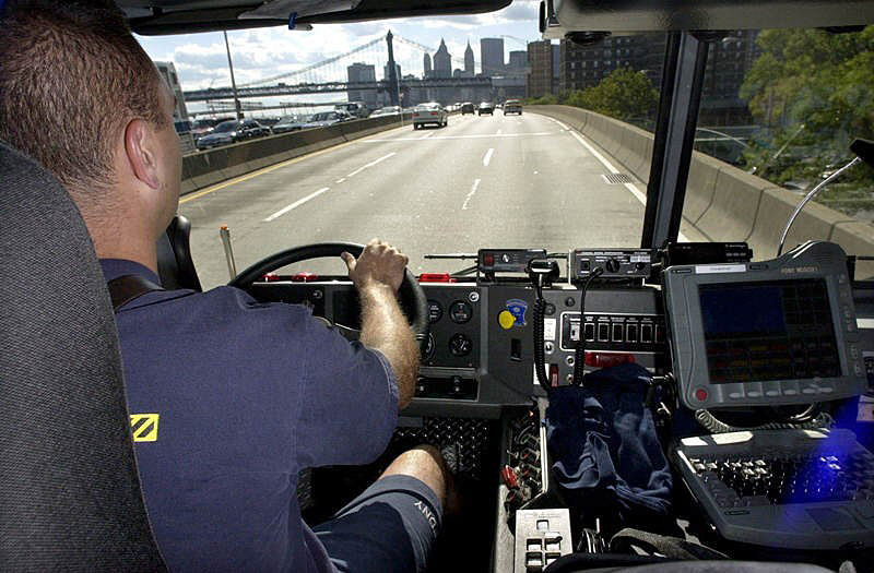 Kevin Ekberg, a Ladder 10 Company firefighter chauffeur, cruises in 10 Truck in Manhattan, returning to the financial district after covering for another company on the lower east side.  Photo by Mike De Sisti 8/9/02 © 2002 Appleton Post-Crescent