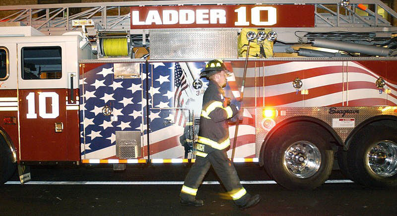 Dan Cavanaugh passes Ladder 10 truck during a recent call to a fire.  Photo by Mike De Sisti 8/10/02 © 2002 Appleton Post-Crescent