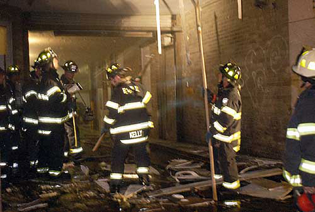 Ladder 10 firefighters, joined by Engine 4 and Ladder 15 companies, work to extinguish a fire on Church Street. Ladder 10 Company is making its runs from a temporary berth at the Engine 4, Ladder 15 firehouse on South Street.  Photo by Mike De Sisti © 2002 Appleton Post-Crescent