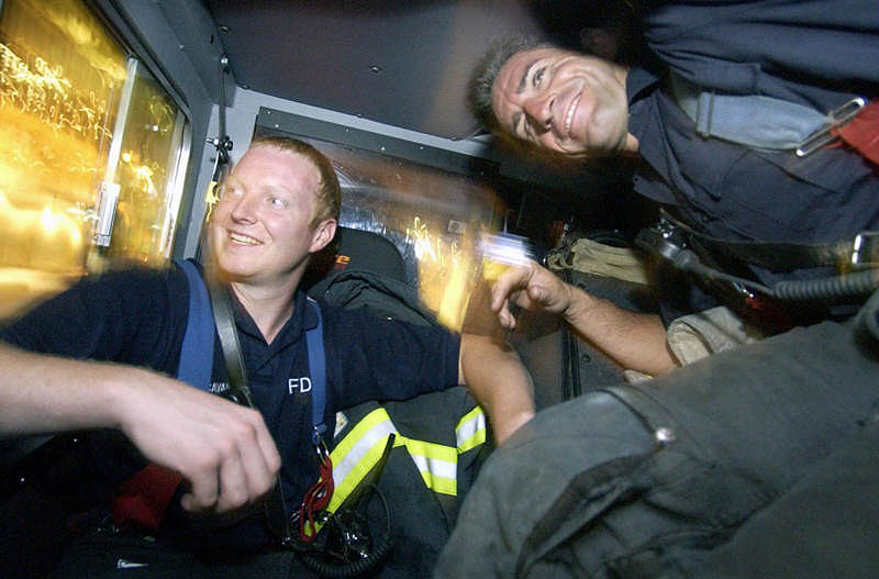 ON A RUN: Ladder 10 Company firefighters return from responding to a garage fire on Liberty St. in Manhattan's financial district.  Photo by Mike De Sisti 8/7/02 © 2002 Appleton Post-Crescent