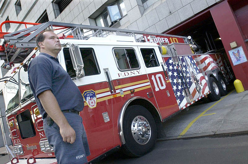 Ladder 10 Company's Eddie Thompson stands by the Ladder 10 truck as it rolls on to the street in front of the crews' temporary South Street station. Ten House, directly across the street from World Trade Center site, was badly damaged due to the September 11th terrorist attacks.  Photo by Mike De Sisti © 2002 Appleton Post-Crescent