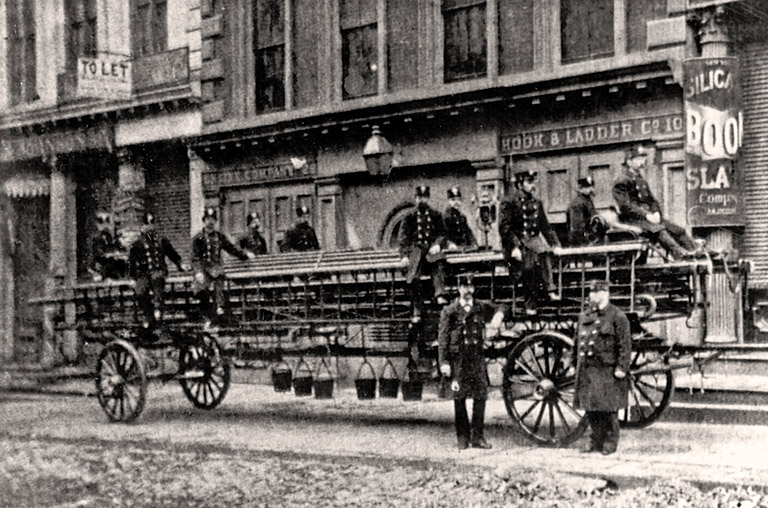Horse Drawn Hook & Ladder. Rig is parked in front of quarters with Members. Photo FDNY George F. Mand Library