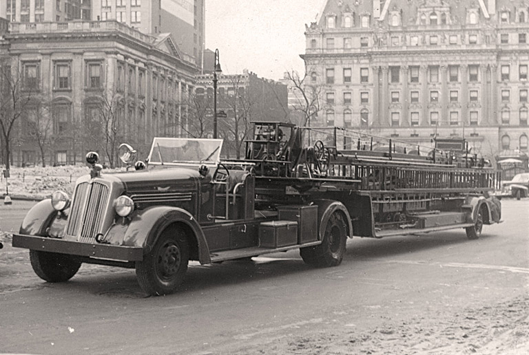 1941 Seagrave 75' Wooden Aerial. Rig parked in street. Photo FDNY George F. Mand Library