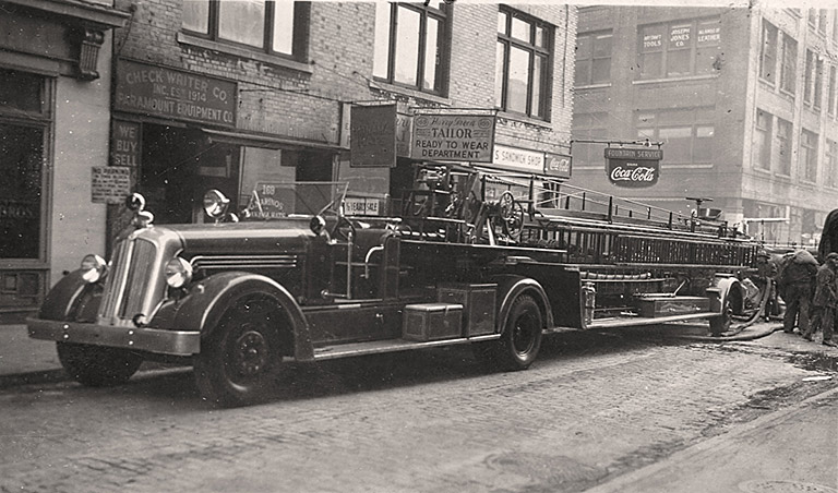 1941 Seagrave 75' Wooden Aerial. New York.Fire scene, hoseline visible on right side of photo. Photo FDNY George F. Mand Library