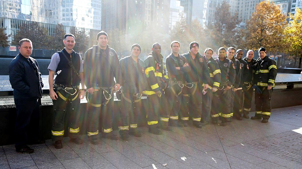 Ten House members place flowers on Veterans names at the 911 Memorial fountains.