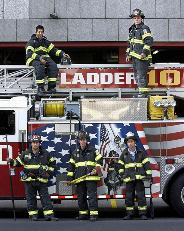 Ladder 10 firefighters pose next to their aerial truck built by Seagrave Fire Apparatus in Clintonville, WI and painted with a special mural to honor New York firefighters following the Sept. 11 attacks.  Photo by Mike De Sisti 8/10/02 © 2002 Appleton Post-Crescent