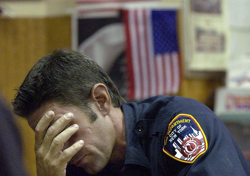 A Ladder 10 firefighter reacts as he talks about how he thought his brother, also a New York firefighter, was dead during the chaotic scene at the World Trade Center last Sept. 11. His brother, a member of Engine 228 in Brooklyn, was on the scene but survived.  Photo by Mike De Sisti 8/7/02 © 2002 Appleton Post-Crescent